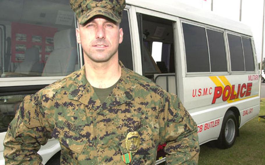 Marine Gunnery Sgt. James Roberto of the Provost Marshal&#39;s Office on Camp Foster, Okinawa, stands in front of the new Mobile Command Post. Military police refitted a small school bus destined for the scrap heap to serve as an on-scene coordination point for responses.