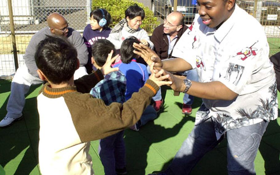 Seaman David John, from the USS Safeguard operating from Sasebo Naval Base, said he had a fantastic time Sunday afternoon playing on a base playground with visiting Japanese orphans. "This is what the holiday season is all about," said John. "It&#39;s about the kids."