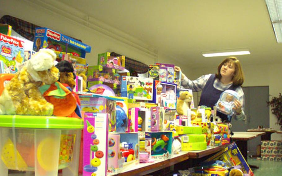 Beth Duncan, the 415th Base Support Battalion’s Holiday Outreach Program officer, sorts toys being given to lower-income soldiers and their families this holiday season. The program collected toys through drop boxes at area exchanges, USO offices and other locations. Someone even left a brand new bicycle, still in the box, Duncan said.