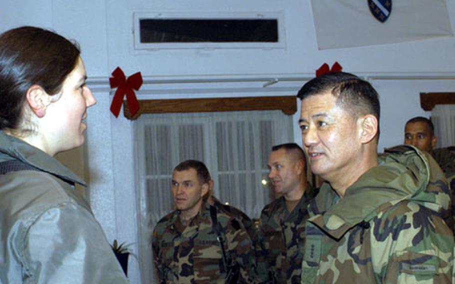 Army Chief of Staff Gen. Eric Shinseki talks to 1st lt. Anne-Marie Hostetler of 1st Battalion, 183rd Aviation Regiment during his holiday visit to American troops in Bosnia.