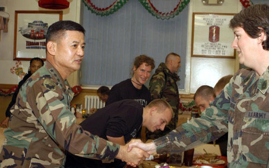 Army Chief of Staff Gen. Eric Shinseki shakes hands with a soldier during his holiday visit to American troops in Bosnia.
