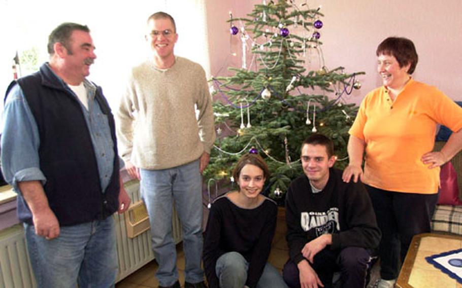 The Bolger family poses with Spec. Matt Watson, second from left, Tuesday afternoon. From left, Klaus Bolgner, Watson, Simone Borgner, Dennis Borger and Hannelore Borger. The family has opened their Homberg home since 1994 to U.S. soldiers to let them experience a traditional Christmas in a small German village.