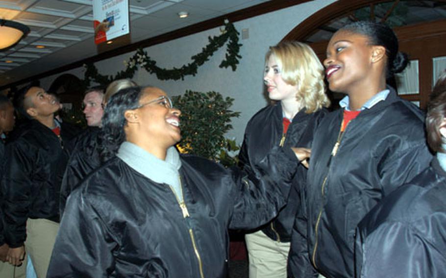 Staff Sgt Evelyn Bruce (left) and Senior Airman Tonie Dickerson share a laugh Saturday night at Yokota Air Base&#39;s Officers&#39; Club, after a social during which the Tops in Blue troupe met base officials. The group puts on more than 100 shows a year across the globe.