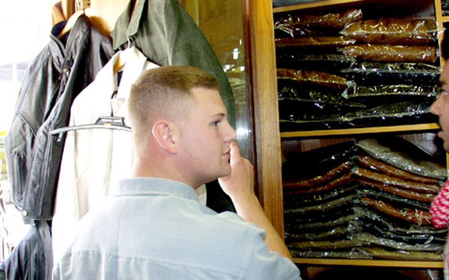 Marine Cpl. Andrew Truesdell shops for a leather jacket at a booth in Kuwait City’s old souk.