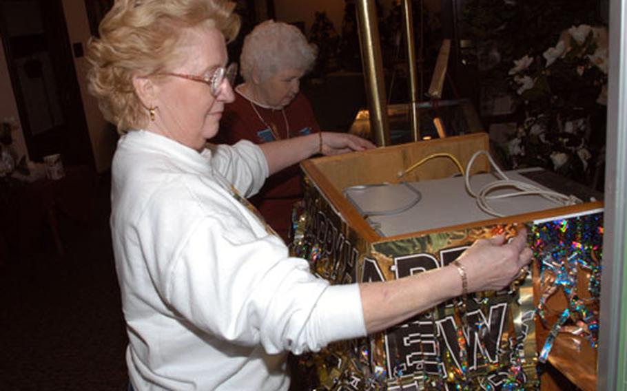 Yokota Air Base Officers&#39; Club General Manager Linda Danner decorated the club&#39;s foyer Tuesday with her mother, Kathleen Powell, for the New Year&#39;s Eve party. The club was named best in the Air Force for fiscal 2001-02 and plans to expand its programs in 2003.