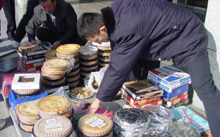 Officers of Korean National Police assigned to Nam-bu station in Taegu, South Korea, sort just some of the 136 pies and other baked goods dropped off at their headquarters by the U.S. Army to thank the cops for round-the-clock guard duty they pull outside three installations in Taegu, Camps Henry, Walker, and George.