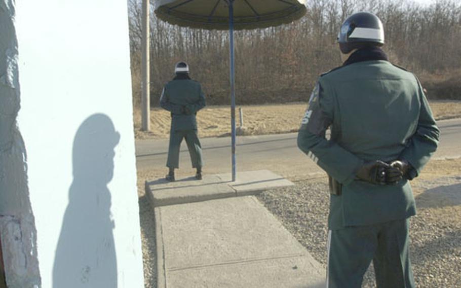 Republic of Korea (ROK) Army soldiers guard the road leading to Tae Sung Freedom Village, located on the southern side of the Demilitarized Zone.