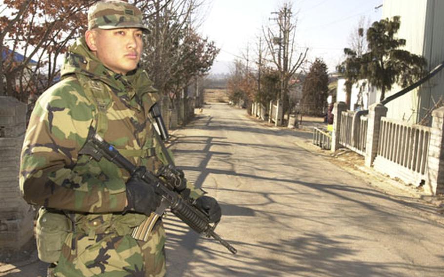 A Republic of Korea (ROK) Army soldier stands guard along one of the streets of Tae Sung Freedom Village. The street leads towards North Korea. Soldiers from the joint US /ROK Battalion provide security for the 226 residents of the village 24 hours a day.