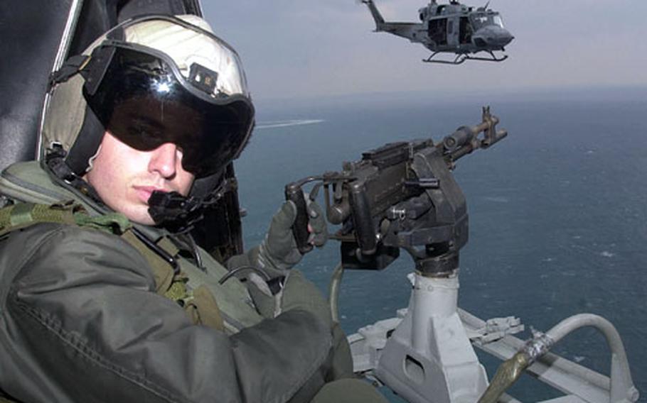 Marine Cpl. Paul O&#39;Brien awaits arrival at the target while in a formation flight off the coast of Okinawa.