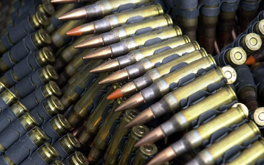 Belted 7.62mm rounds dumped in a heap prior to being loaded in the M-240G machine guns mounted on the doors of a UH-1N Huey.