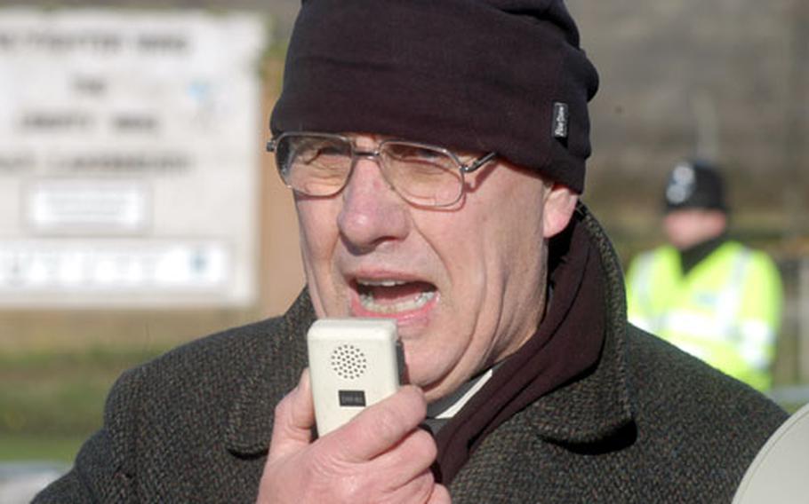 The Rev. Howard Cresswell of Norwich, England, speaks Monday during a demonstration at RAF Lakenheath, England. About 70 people visited the base&#39;s front gate to demonstrate against possible war with Iraq.