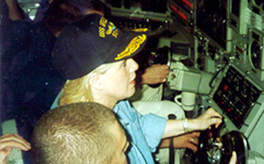 Tipper Gore sits at the helm of the USS Greeneville in Feb. 1999, one of many visitors to embark on the sub.