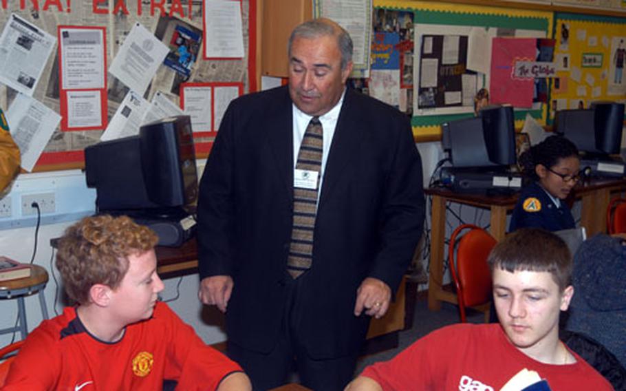 Joseph Tafoya, director of the Department of Defense Education Activity, chats Monday with Alconbury High School freshmen Max Reuning, left, and Nick Ladeau.