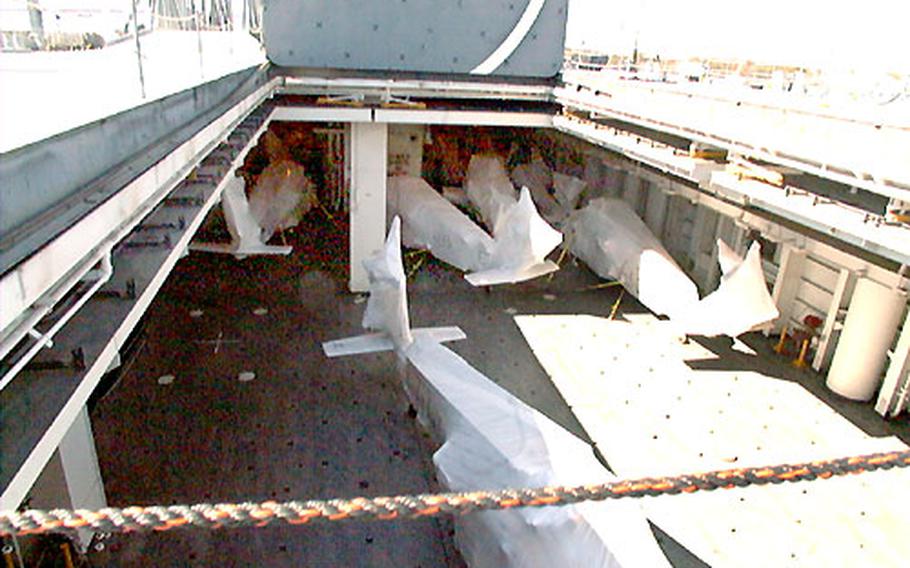 “Cocooned” helicopters from the Army’s 101st Airborne Division (Air Assault), to include Apache, Black Hawk and Chinook helicopters, are stored Thursday on one of six decks of the USNS Bob Hope.