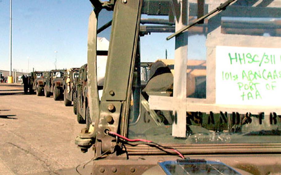 Humvees from the Army&#39;s 101st Airborne Division wait to be loaded onto the transport vessel USNS Dahl.