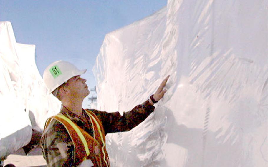 Pfc. Ben Eggers, 25, had to “cocoon,” or shrink-wrap, helicopters before the aircraft could be loaded on to transport vehicles heading for the Persian Gulf.