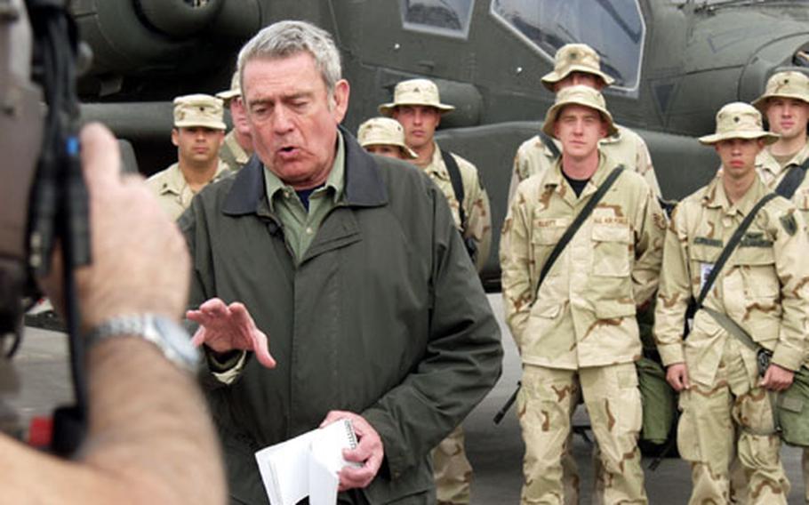 CBS News anchorman Dan Rather does a live broadcast in front of a crowd of 11th Aviation Regiment headquarters company soldiers from Illesheim, Germany, at Camp Udairi, Kuwait.