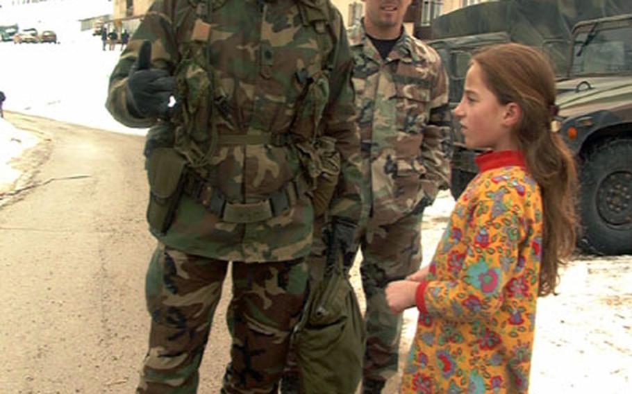 Lt. Col. Clifford Cadle, commander of Civil Affairs Team 6, left, talks with Liridona Mehmeti, right, along with translator Patrik Shehu on Friday in Novo Brdo.