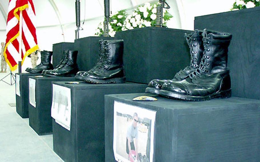 The boots, rifles, helmets and patches of four soldiers from the 5th Battalion, 158th Aviation Regiment who died when a UH-60 Black Hawk crashed this week rest above their photos at Wednesday&#39;s memorial service.