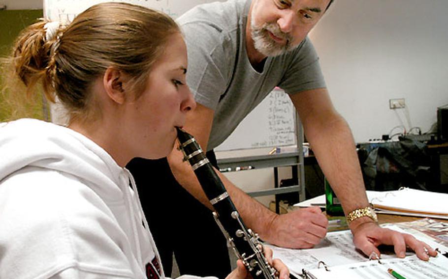 Instructor Tom Donaldson listens as Kelly Birch from Lajes High School, the Azores, plays a piece she composed in the "Play it by ear: Melodies, Harmonies and Arrangements" workshop.