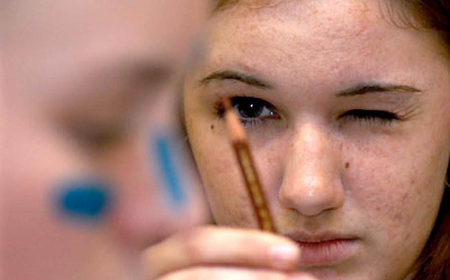 In the "Multi-Dimensional Drawing" workshop at Creative Connections in Oberwesel, Germany, Sarah Gill, a student from Incirlik High School, Turkey, takes measure of Chelsea Blandford of Brussels High School, Belgium, before sketching her.