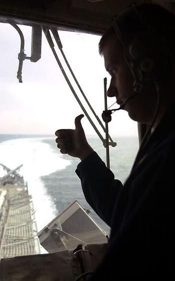 Ensign gives thumbs-up from helicopter control tower