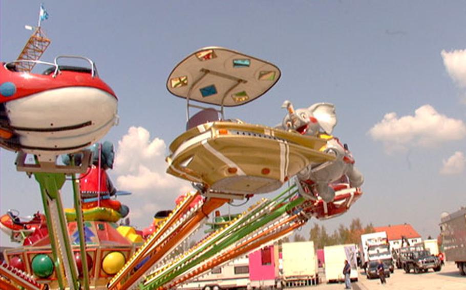 Workers begin to set up rides and booths for the German/American Volksfest at Warner Barracks on Tuesday. The festival takes place Wednesday through May 1 in Bamberg, and is open to the public.