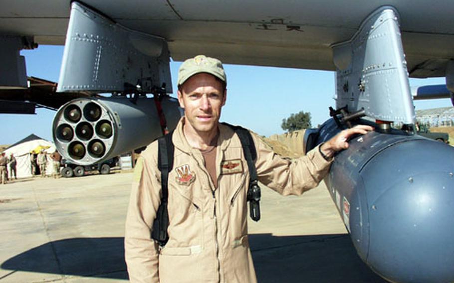 Lt. Col. Steve Chappel, commander of the 303rd Fighter Squadron, points out the targeting pod on an A-10 aircraft Wednesday. It allows pilots to monitor and record movement on the ground from as high as four miles, while relaying the information about enemies to U.S. ground troops.