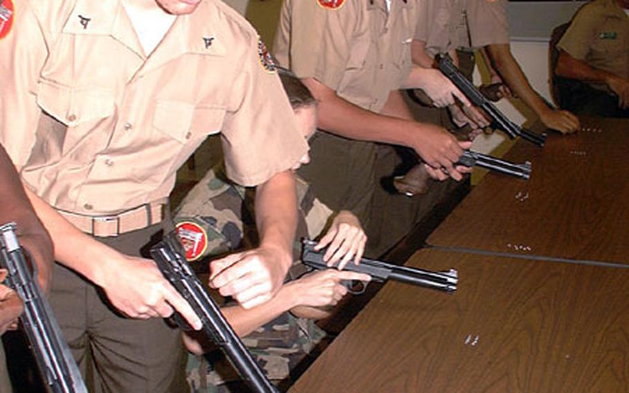 Marine JROTC cadets from Kubasaki High School earn points toward their grade in the JROTC course, as well as marksmanship badges they&#39;ll carry through next year&#39;s course of studies.