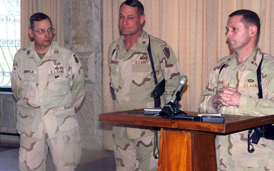 From left, Army Col. Mike Hawrylak, Coalition Forces Land Component Command deputy operations officer, Army Brig. Gen. Steven Hawkins, commander of Task Force Fajr, and Army Brig. Gen. Daniel Hahn, V Corp chief of staff, discuss recent operations in Iraq on Thursday. They were in the presidential palace on Victory Camp in Baghdad.