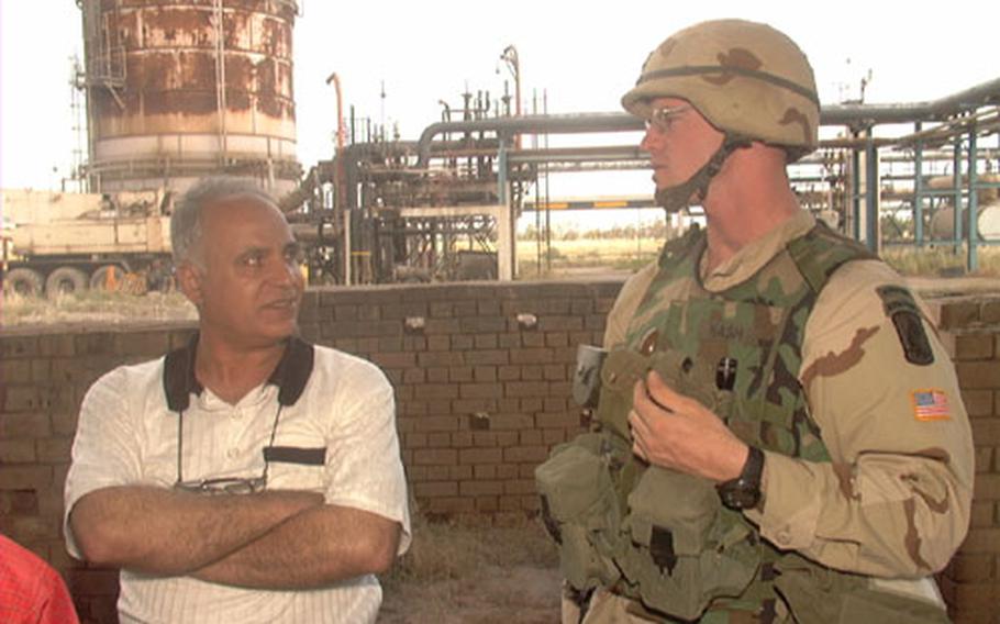 The Kirkuk facility also produces natural gas, according to Hassan Shunasi, the facility&#39;s shift control operator. Pictured with Shunasi is U.S. Army 1st Lt. Brian Nash, 25, of East Grand Rapids, Mich. Nash is the executive officer for Delta Battery, 319th Field Artillery, 173rd Airborne Brigade.