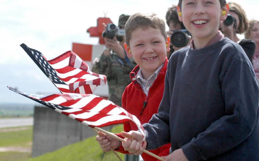 Alex, left, and Dalton wave American flags as they watch their dad Lt. Col. Hank Reed land his F-16CJ aircraft at Spangdahlem Air Base, Germany, Thursday. About 24 airplanes of the 52nd Fighter Wing&#39;s 22nd and 23rd Fighter Squadrons returned to this base in Germany&#39;s Eifel mountains from an undisclosed location after flying missions for Operation Iraqi Freedom. Reed is the commander of the 22nd Fighter Squadron.