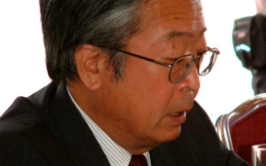 Saadaki Numata, ambassador in charge of Okinawan affairs, addresses the Tripartite Liaison Committee Friday.