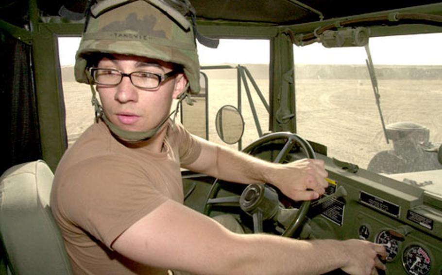 Spc. Seid Tanovic, 20, a native of Bosnia and Herzegovina, backs up his M818 five-ton truck during a recent truck rodeo.