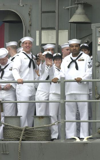 Sailors wave as they return to Yokosuka Naval Base