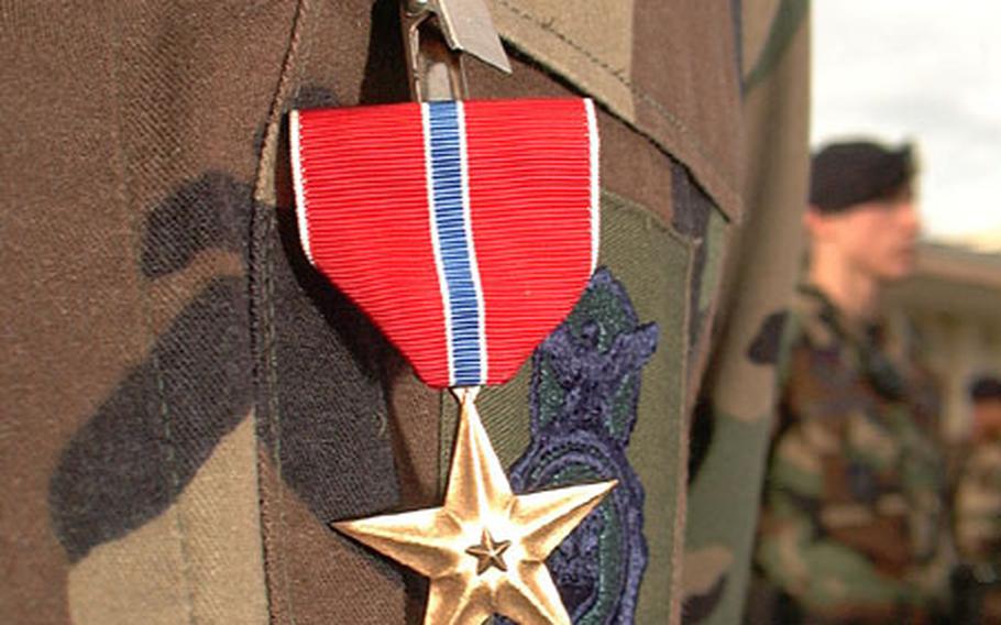 Air Force Master Sgt. Daniel Arvin&#39;s newly awarded Bronze Star Medal stands in stark contrast to his subdued camouflage uniform. Arvin received the Bronze Star for his actions while stationed in the Middle East.