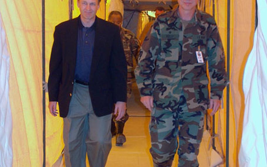 Capt. Pat Kelly, commanding officer of Fleet Hospital Eight in Rota, Spain, gives Dr. William Winkenwerder a tour of the fleet hospital. The tent facility has treated more than 500 patients since the war in Iraq began March 20.