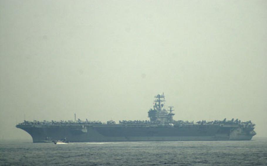 The USS Carl Vinson prepares to drop anchor off the coast of Yokosuka Naval Base. The Vinson brings more than 6,000 sailors on a scheduled port visit.