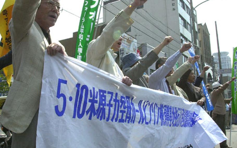 Japanese demonstrators chant slogans protesting the arrival of the USS Carl Vinson, the war in Iraq and the presence of U.S. Navy forces in Japan.