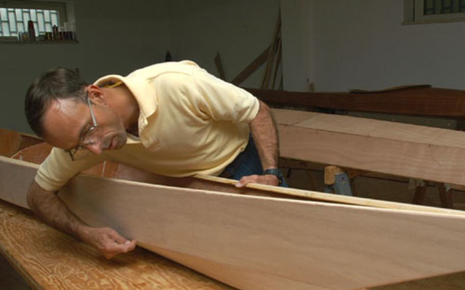Capt. Darrell Van Hutten shows where epoxy seals together panels to create a kayak.