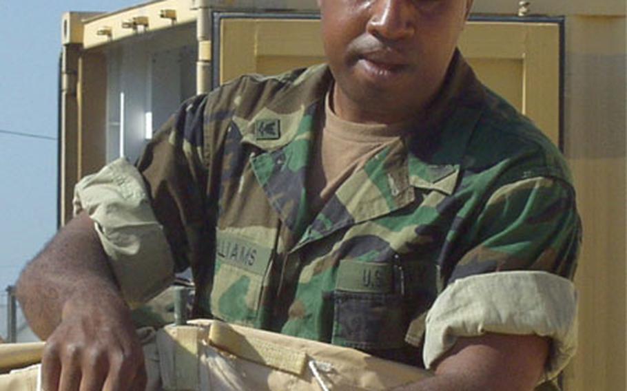 Petty Officer 3rd Class Zealous Williams helps dismantle a tent Friday at Naval Station Rota, Spain.