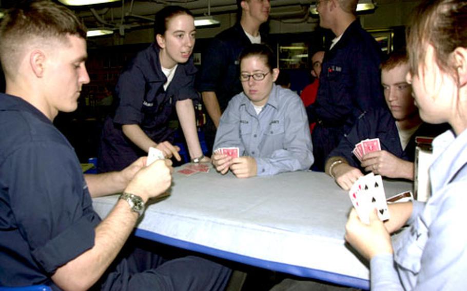 Sailors on board the USS Carl Vinson played a game of spades Friday night on the eve of making a port call in Yokosuka, Japan. About a quarter of the crew stays on the aircraft carrier during a liberty stop.