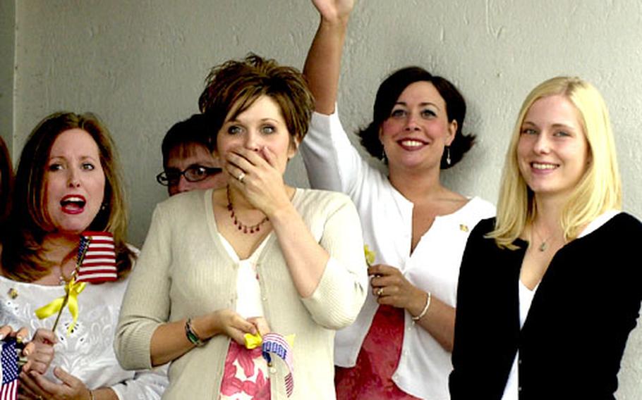 Wives of members of the 159th Medical Company, out of Wiesbaden, Germany, react as their husbands get off the bus that brought them from Ramstein Air Base upon their return from Operation Iraqi Freedom.