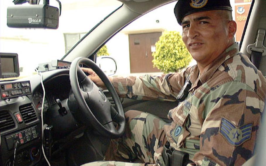 Air Force Staff Sgt. Roldofo Calderon sits in the driver&#39;s seat of the new Traffic Enforcement vehicle equipped with forward and backward-looking radar and in-car cameras to record traffic stops.