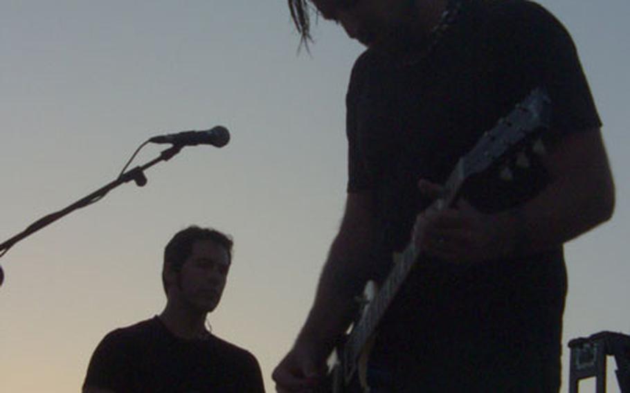 As the sun sets, Dishwalla guitarist Rodney Browning Cravens, right, performs with singer J.R. Richards, in the background.