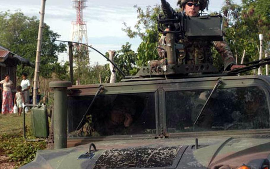 Armored humvees and heavily-armed Marines patrol the village near a Medical Civil Action Project, or MEDCAP, held by U.S. and Philippine forces near Zamboanga City in the Southern Philippines. Classified by President Bush as part of the War on Terror, the southern Philippines is one of the most hostile and dangerous places for U.S. forces in Asia.