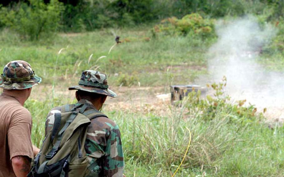 U.S. Navy Explosive Ordnance Disposal Mobile Unit 5 personnel and Royal Thai servicemembers blow up a potential explosive Saturday as part of a mine-disruption demonstration during Cobra Gold in Thailand.