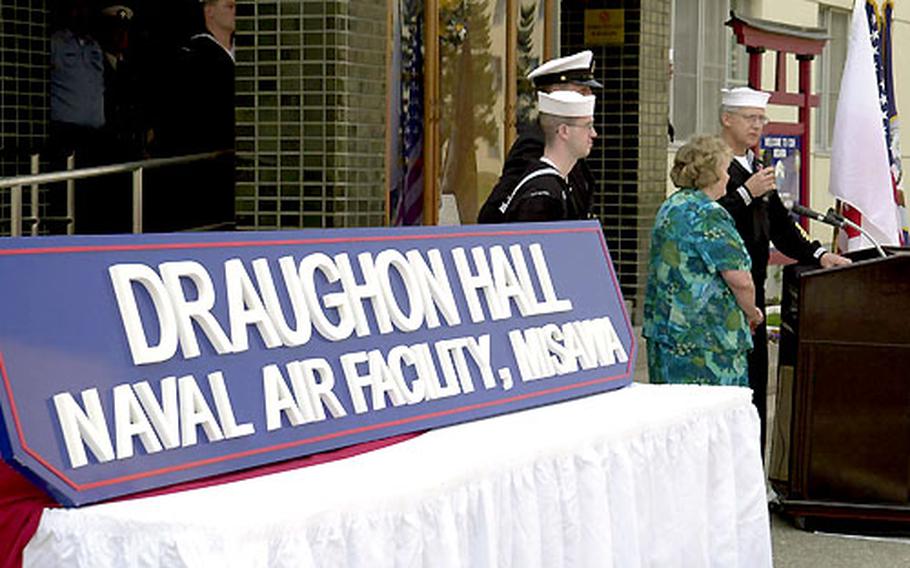 A sign proclaiming Draughon Hall is unveiled earlier this month at Misawa Air Base, Japan, during a ceremony honoring a Navy diver who died two years ago while salvaging F-16 crash wreckage in the Pacific Ocean near the base.