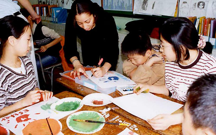 U.S. Army Sgt. Koren Chavis teaches children at Seoul&#39;s Itaewon Elementary School as part of the Virtues Development Project.