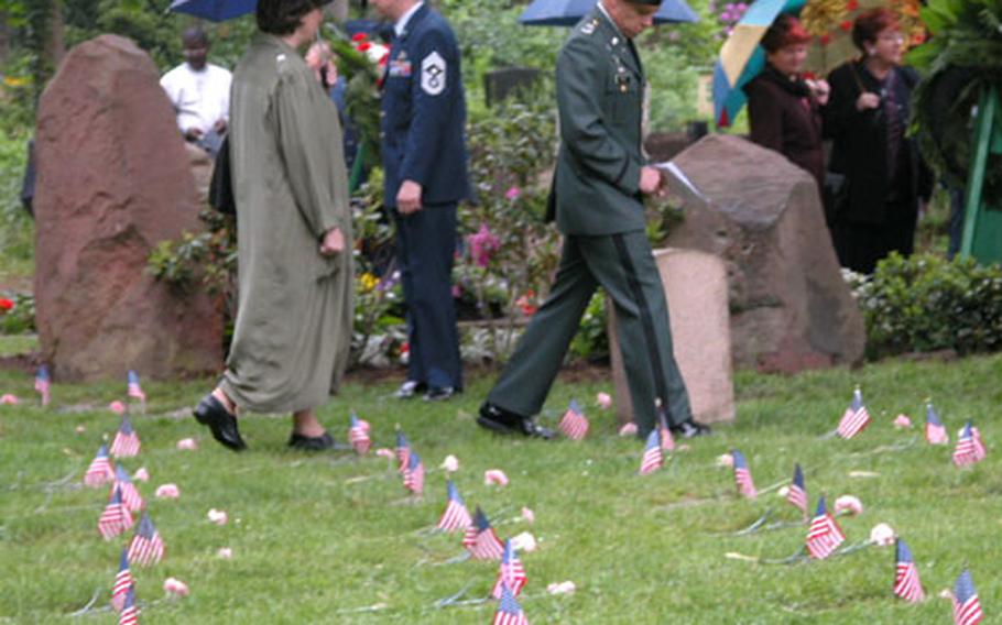 Spectators walk among the children&#39;s graves following the May 17 ceremony to honor the memory of the 451 infants of U.S. servicemembers buried at the Kaiserslautern cemetery.